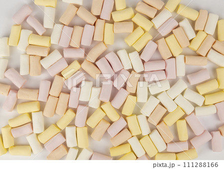 Pink yellow and white marshmallow background. The concept of colored marshmallows. Pink yellow and white marshmallow background. The concept of colored marshmallows. 111288166