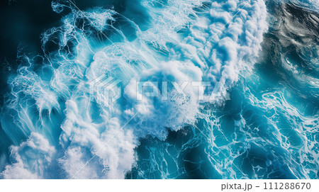 Aerial view capturing the intricate patterns of foam and waves in the turquoise ocean, creating a beautiful natural abstract. 111288670