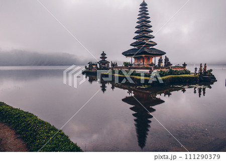 Reflection in the cloudy day of Pura Ulan Danu Bratan a famous picturesque landmark and a significant temple on the shores of Lake Bratan in Bali, Indonesia. Reflection in the cloudy day of Pura Ulan Danu Bratan a famous picturesque landmark and a significant temple on the shores of Lake Bratan in Bali, Indonesia. 111290379