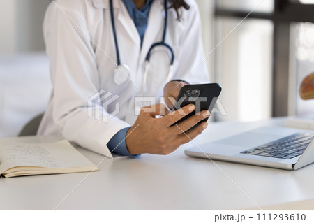 Hands of young female doctor using smartphone at workplace Hands of young female doctor using smartphone at workplace 111293610