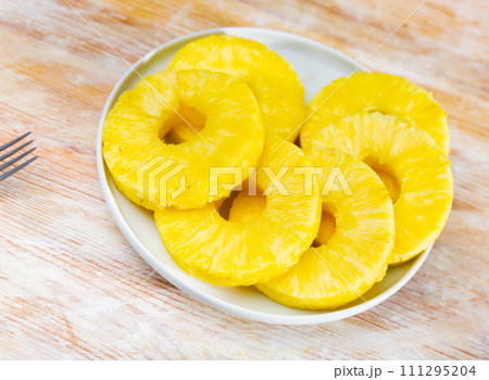 Pineapple rings served on table Pineapple rings served on table 111295204