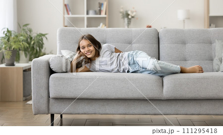Happy positive lazy pre teen kid girl enjoying leisure, relaxation Happy positive lazy pre teen kid girl enjoying leisure, relaxation 111295418