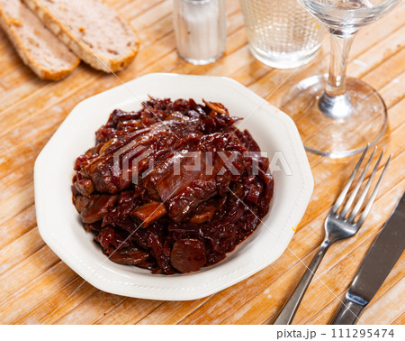 On plate there is stewed cabbage with delicious pork ribs On plate there is stewed cabbage with delicious pork ribs 111295474