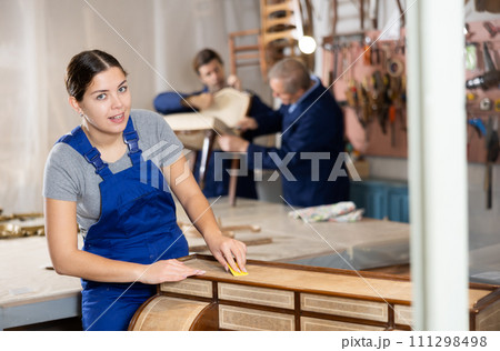 Portrait of skillful repair woman carpenter renovating dresser furniture using tools in woodwork studio Portrait of skillful repair woman carpenter renovating dresser furniture using tools in woodwork studio 111298498