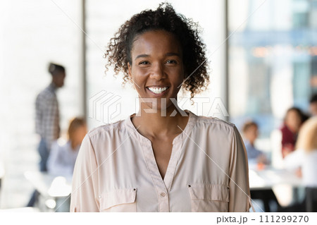 Happy smiling millennial mixed race woman student posing at university Happy smiling millennial mixed race woman student posing at university 111299270