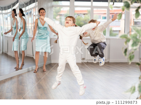 Cheerful girl jumping during dance lesson in choreography studio 111299873