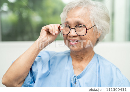 Asian senior woman wearing eyeglasses or vision glasses at home care service. Asian senior woman wearing eyeglasses or vision glasses at home care service. 111300451