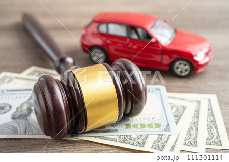 Hammer gavel judge and US dollar banknote money with car vehicle accident, insurance coverage claim lawsuit court case. 111301114