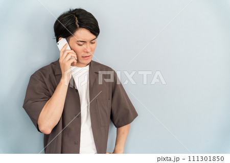 スマホで通話する男性（不機嫌・不満・ネガティヴ・クレーム・ストレス・怒る） 111301850