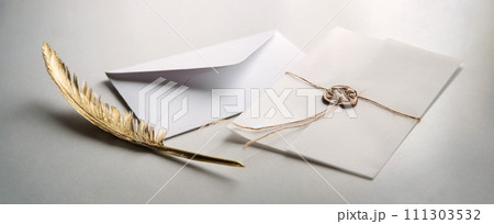 Golden pen and stamped envelope 111303532
