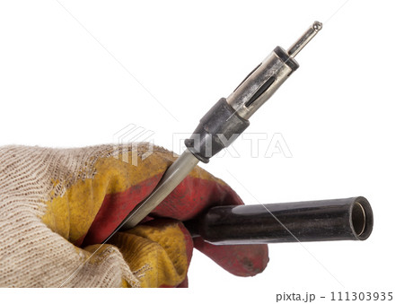 A car audio connector or trailer for closing an electrical circuit that a mechanic holds in gloves during repairs. A car audio connector or trailer for closing an electrical circuit that a mechanic holds in gloves during repairs. 111303935