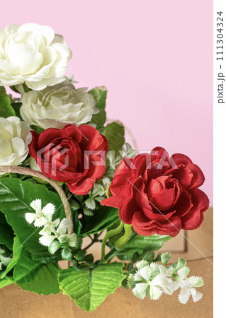 Bouquet of red and white roses in box on pink background. Bouquet of red and white roses in box on pink background. 111304324