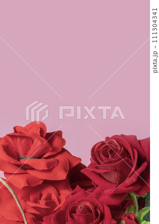 Bouquet of colorful artificial red roses on pink background with copy space for your text. 111304341