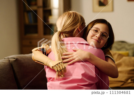 Mother and daughter in embrace 111304681