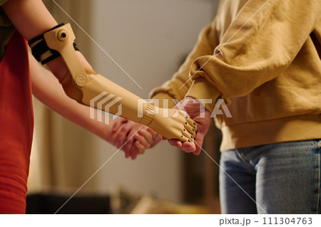 Mother and daughter holding by hands 111304763