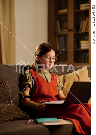 Schoolgirl looking at laptop screen 111304783