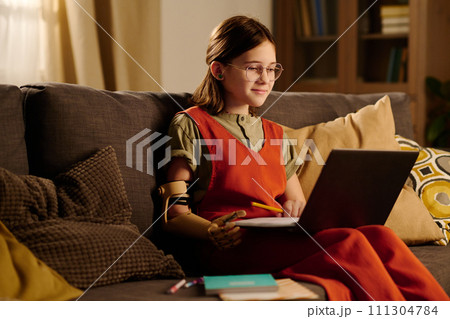 Diligent girl having online lesson 111304784
