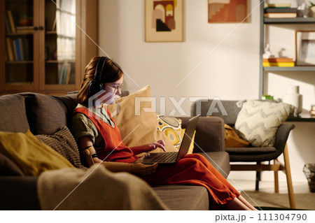 Girl with disability using laptop 111304790