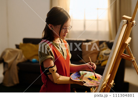 Girl with palette in myoelectric hand 111304801