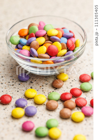 Colorful sweet candies in bowl on kitchen table. Colorful sweet candies in bowl on kitchen table. 111305405