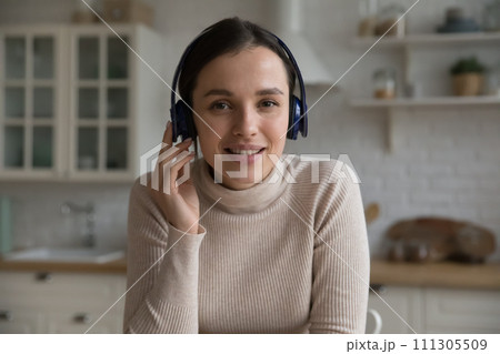 Attractive young woman in headphones take part in videoconference 111305509