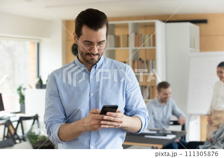 Caucasian male employee use cellphone texting Caucasian male employee use cellphone texting 111305876