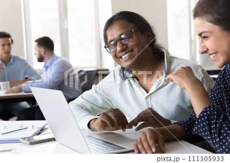 Two happy cheerful Indian business colleagues talking on video call 111305933