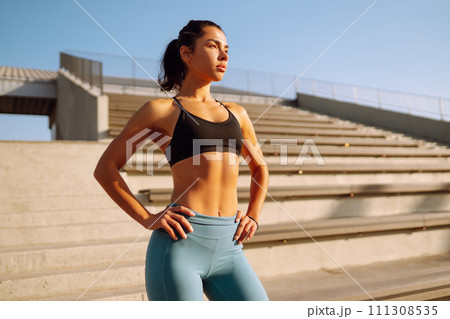Fit Young woman in sportswear doing yoga, fitness exercise on the street. Sport, Active life. Fit Young woman in sportswear doing yoga, fitness exercise on the street. Sport, Active life. 111308535
