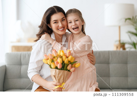 daughter and mom with flowers 111309558