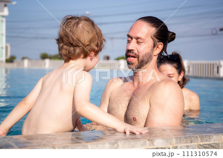Caucasian family having enjoy and fun together with happiness in swimming pool. 111310574