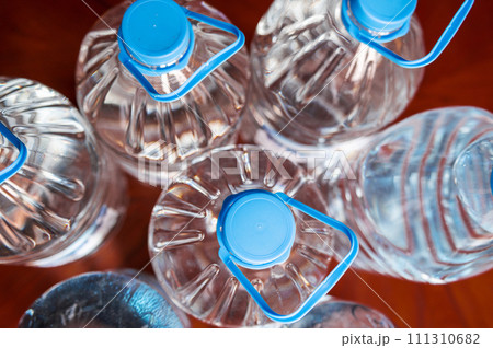 Bottles of water.. Stock of bottled water. Preparing for a food crisis. Selective focus 111310682