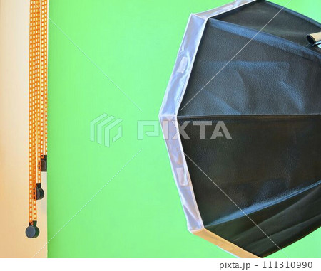 Empty photo studio with lighting equipment. Green background in photo studio Empty photo studio with lighting equipment. Green background in photo studio 111310990