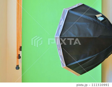 Empty photo studio with lighting equipment. Green background in photo studio Empty photo studio with lighting equipment. Green background in photo studio 111310991