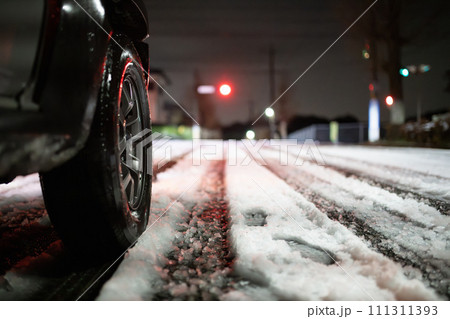 雪の積もった交差点と自動車のタイヤ 雪の積もった交差点と自動車のタイヤ 111311393