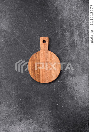 Empty wooden cutting board on a light texture background Empty wooden cutting board on a light texture background 111312577