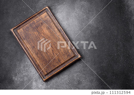 Empty wooden cutting board on a light texture background Empty wooden cutting board on a light texture background 111312594