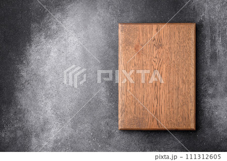 Empty wooden cutting board on a light texture background Empty wooden cutting board on a light texture background 111312605
