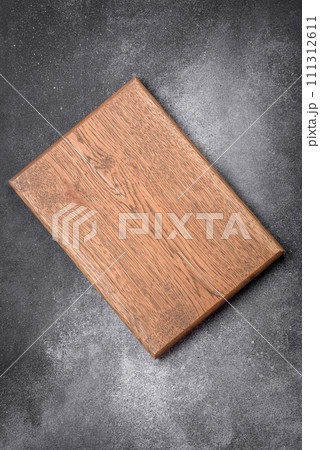 Empty wooden cutting board on a light texture background 111312611