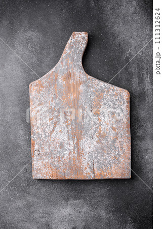 Empty wooden cutting board on a light texture background 111312624