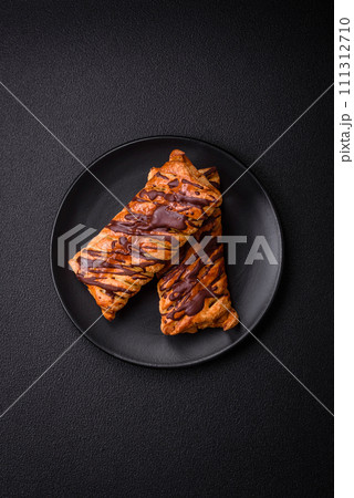 Delicious crispy sweet puff pastry with chocolate and salted caramel 111312710