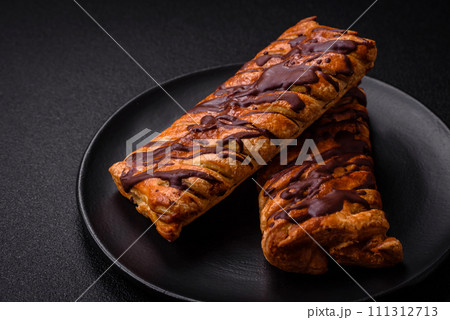 Delicious crispy sweet puff pastry with chocolate and salted caramel Delicious crispy sweet puff pastry with chocolate and salted caramel 111312713