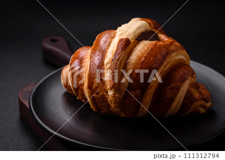 Delicious crispy sweet croissant cornet with chocolate Delicious crispy sweet croissant cornet with chocolate 111312794