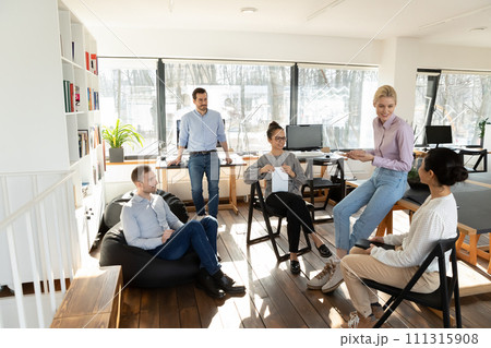 Smiling diverse colleagues brainstorm at casual meeting in office Smiling diverse colleagues brainstorm at casual meeting in office 111315908