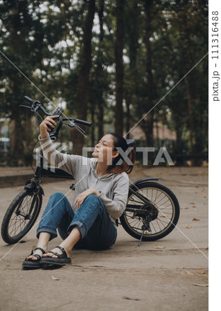 Happy Asian young woman walk and ride bicycle in park, street city her smiling using bike of transportation, ECO friendly, People lifestyle concept. 111316488