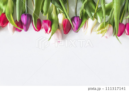 Happy valentines day or international womens day concept; Frame of red, pink and white tulips on a white background; 111317141