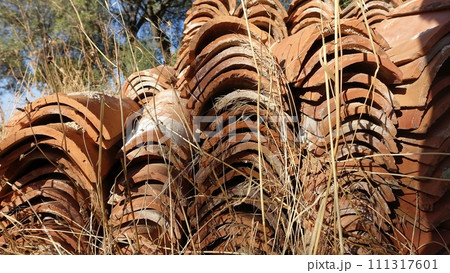 Hundreds of antique roof tiles ready to be used for a new home. Hundreds of antique roof tiles ready to be used for a new home. 111317601