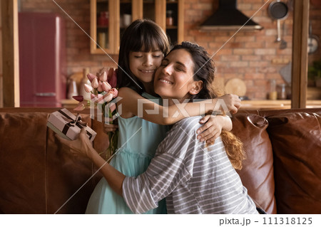 Affectionate latina mother hug daughter receive surprise on Mothers Day Affectionate latina mother hug daughter receive surprise on Mothers Day 111318125