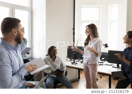Happy confident business project manager woman talking to multiethnic team Happy confident business project manager woman talking to multiethnic team 111318179