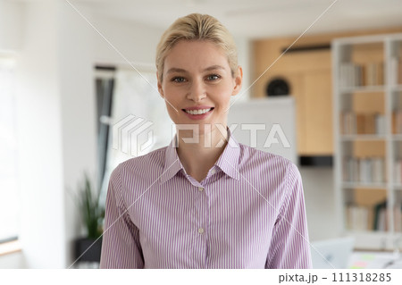 Headshot portrait of smiling female employee in office Headshot portrait of smiling female employee in office 111318285