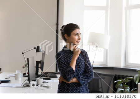 Calm thoughtful beautiful Indian young businesswoman in casual office portrait 111318370